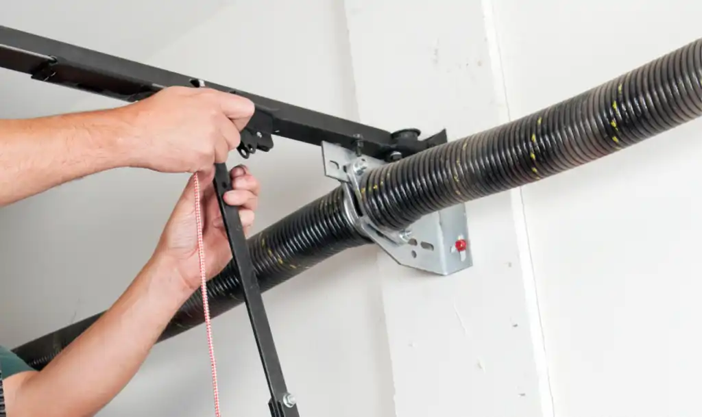 Garage door spring service technician at work